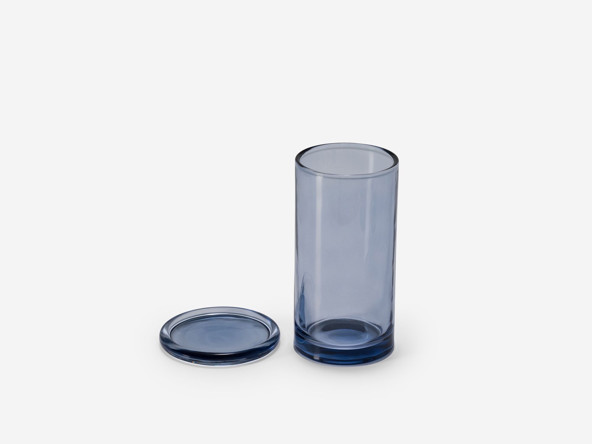 Front view of large glass organization container with lid beside